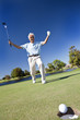 Senior Man Playing Golf Celebrating On Putting Green