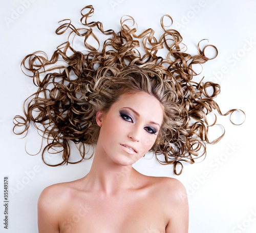 Fototapeta na wymiar Portrait of young woman with long curly hair