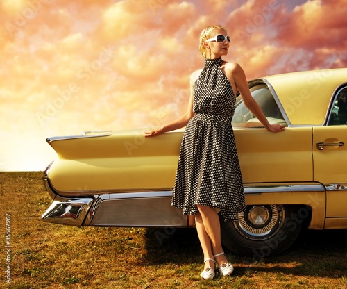 Fototapeta na wymiar Beautiful lady standing near retro car.