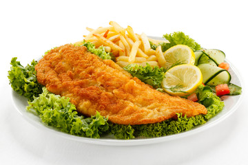 Fish dish - fried fish fillet, French fries with vegetables