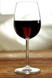 Glass of fine Italian red wine on a table in oak