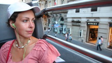 Beautiful Woman Rides On Open Top Floor Of Bus At Streets