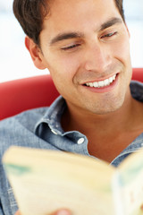 Wall Mural - Young man reading a book