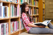© WavebreakmediaMicro - Cute female student holding a book