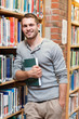 © WavebreakmediaMicro - Portrait of a smiling male student holding a book