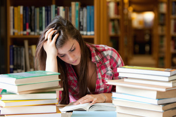Poster - Focused student surrounded by books