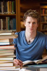 Poster - Portrait of a male student posing with books