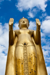 Wall Mural - Golden standing Buddha statue inside a temple in Ubonratchathani