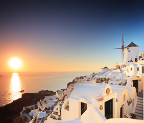 Wall Mural - A view of a village on Santorini island and a sunset