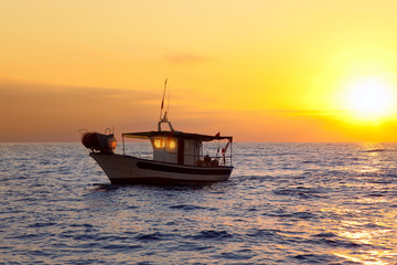 fishing boat in sunrise at Mediterranean sea