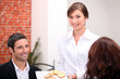 © auremar - Waitress delivering meal in restaurant