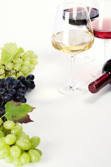 Wall Mural - Glasses of white, red and rose wine and grapes