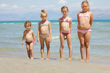 Children With Sun Lotion On The Beach