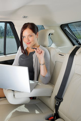 Executive businesswoman work laptop car backseat