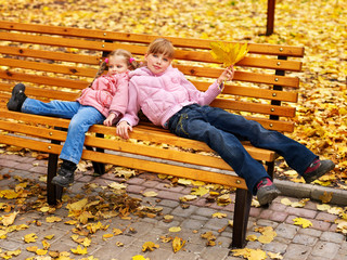Wall Mural - kid in autumn orange leaves.