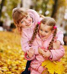 Wall Mural - kids in autumn orange leaves.
