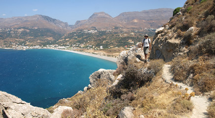 South coast of Crete, young man walking. Plakias, Greece.