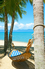 Wall Mural - Empty hammock between palms trees at sandy beach