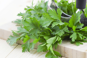 Freshly chopped parsley on wooden cutting board