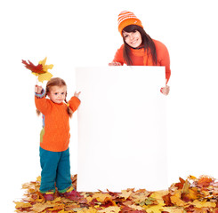 Wall Mural - family with child on autumn leaves holding banner.