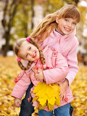 Wall Mural - kids in autumn orange leaves.