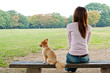 © taka - attractive asian woman with dog in the park
