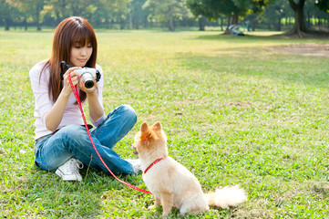 Wall Mural - attractive asian woman with dog in the park