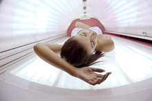 Beautiful Young Woman Tanning In Solarium