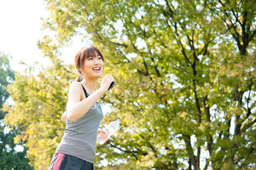 Wall Mural - beautiful asian runnning in the park