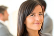© goodluz - Portrait of beautiful businesswoman standing in front of group