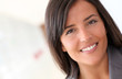 © goodluz - Beautiful saleswoman standing with group of business people
