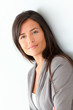 © goodluz - Beautiful businesswoman standing on grey background