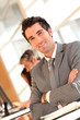 © goodluz - Portrait of smilng businessman with arms crossed