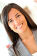 © goodluz - Portrait of beautiful businesswoman standing in front of group