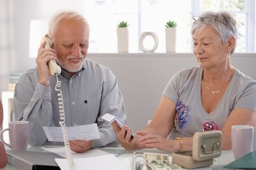 Poster - Elderly couple checking bills at home