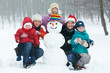 © Kadmy - happy woman with children snowman in winter