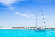 Anchored Sailboats In Turquoise Formentera Beach