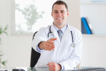 Wall Mural - Smiling doctor welcoming patient