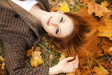 Poster - Portrait of red-haired girl in the autumn park.