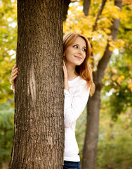 Poster - Portrait of red-haired girl in the autumn park.