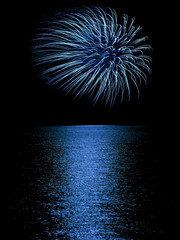 Fireworks reflection on calm but rippled water