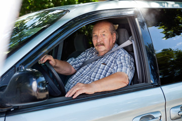 Wall Mural - Senior man driving a car