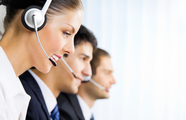 Three support phone operators at workplace