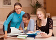 © aleksandrn - Three girls schoolgirl getting ready for the lesson