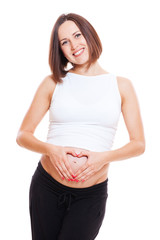 Wall Mural - pregnant woman showing fingers like heart