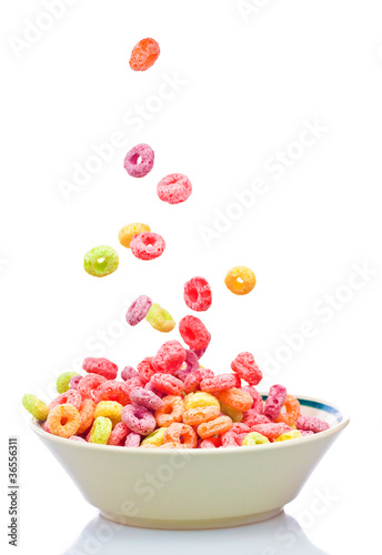 Fotografía Colorful cereal falling into a bowl isolated on white