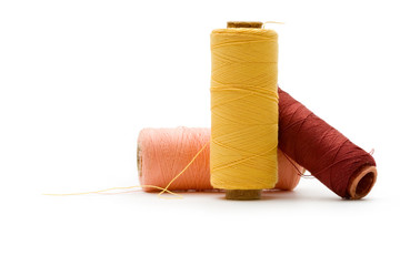 Thread bobbins on the white background