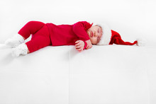 Cute Baby In Santa Hat Sleeping In Christmas Night