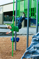 Wall Mural - Child playing at a school playground