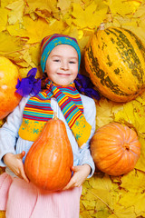 Wall Mural - Smiling girl with pumpkin